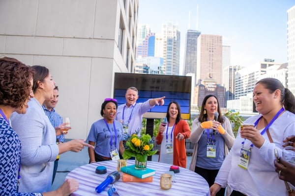 Diverse group of co workers around a table enjoying a corporate event