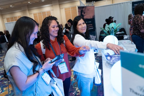 Attendees engaging at interactive event booth