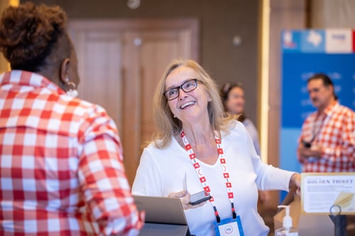 Woman smiling as she checks in for a corporate event