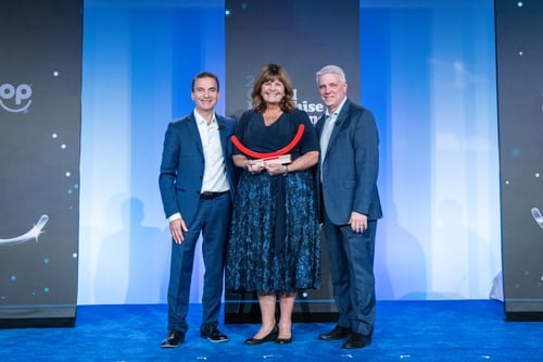 Award winner posing with two presenters