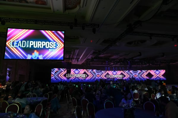 Screens display event logo and message as well as graphic design "Lead with purpose"
