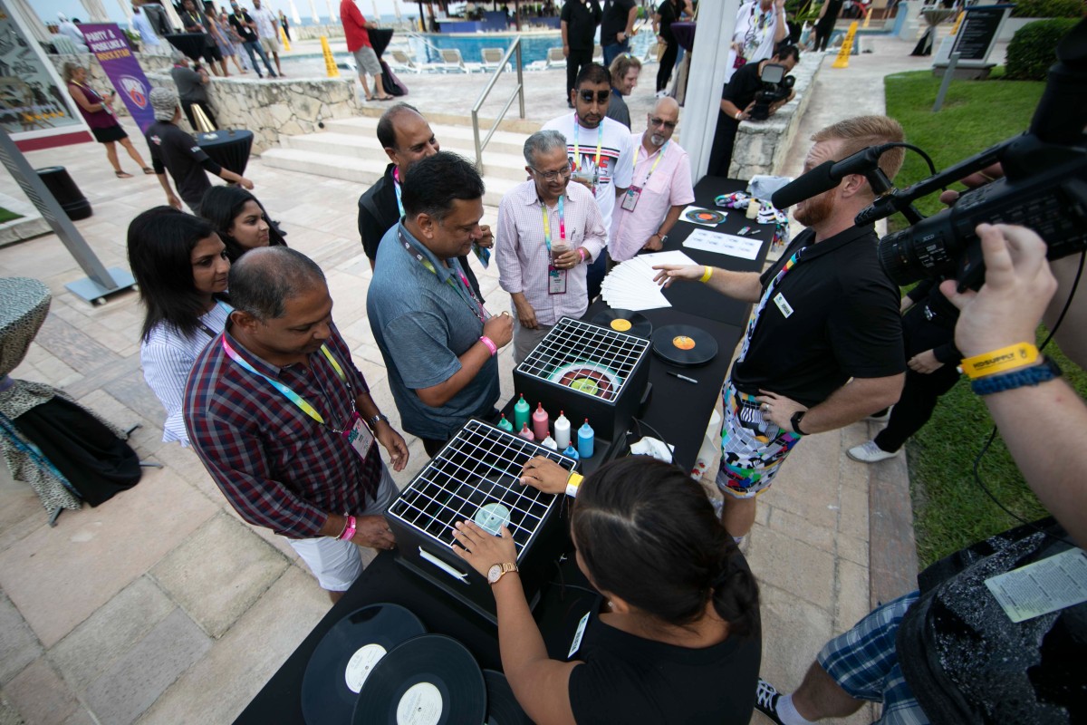 Attendee decorates custom vinyl record as part of personalized event activation