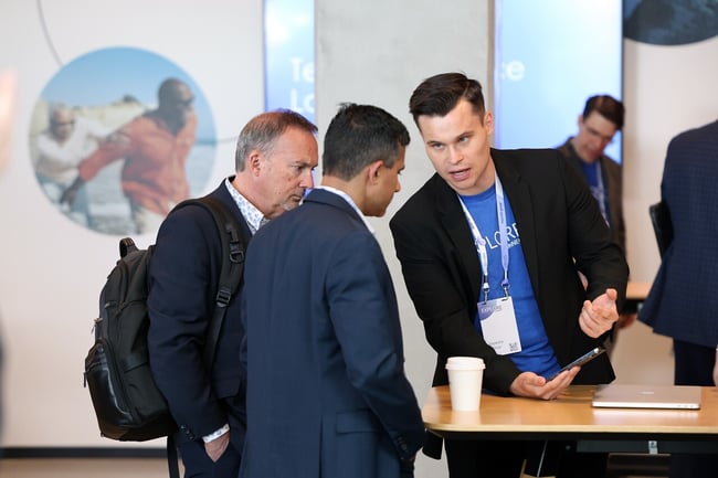 Group of business men discussing information at event table