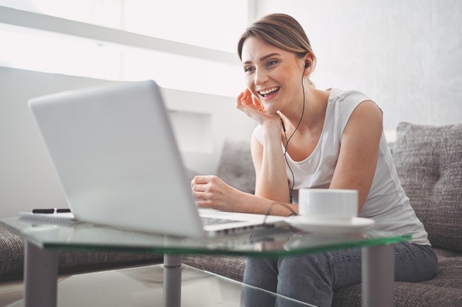 Young woman attends virtual event 348612293