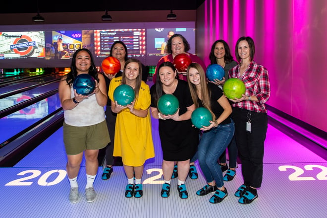 smiling female associates at bowling alley