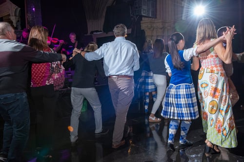 People in a dim room dancing
