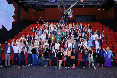 Large group of people posing for picture in auditorium