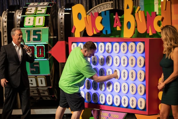 Guests participate in game show-themed event activation at corporate event