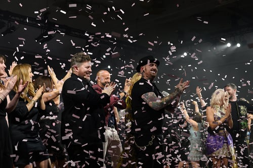 Group applauding at an award event with confetti falling