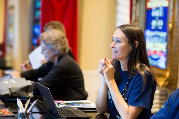 woman at corporate event is enthralled and delighted