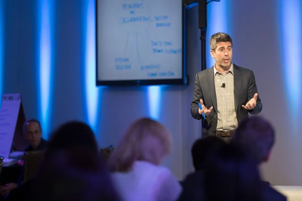 Man speaks to audience at pharma meeting