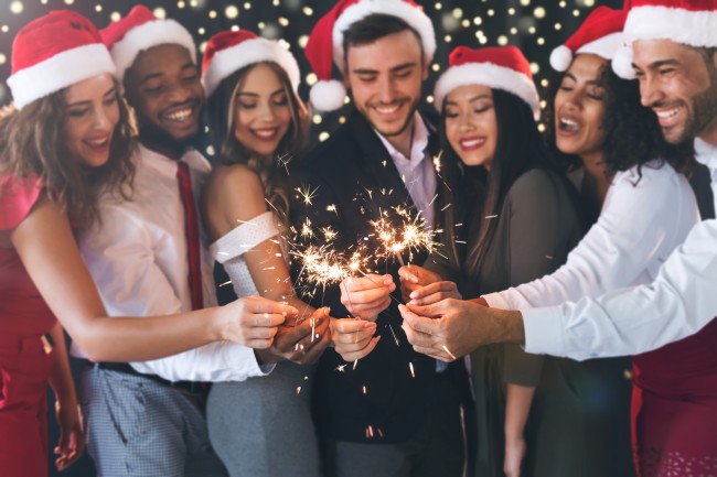 Group of people in santa hats holding sparklers AdobeStock_229933751