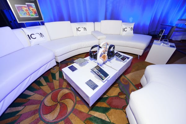 Corporate event lounge with headphones, tablets, and tech