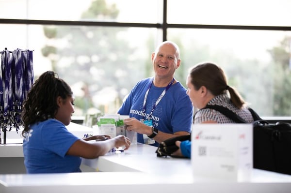 Customer Service person smiling as he prepares for corporate event