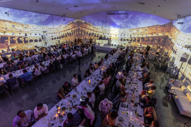 Projection of italy on stage at a large meal during incentive trip