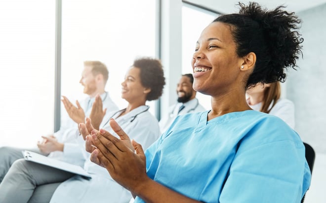 audience clapping at pharmaceutical event