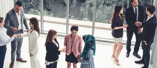 Diverse crowd of people talking in a lobby/meeting spaceAdobeStock_259681414