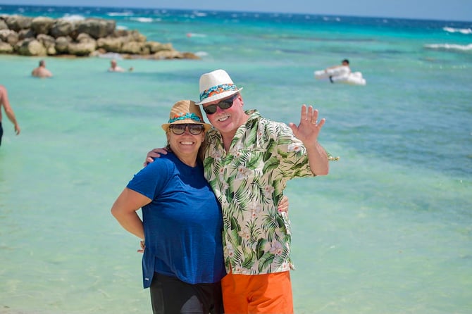 two people smiling on the beach at an incentive program