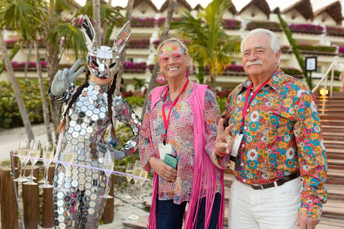 Older couple posing with a disco ball clad bunny